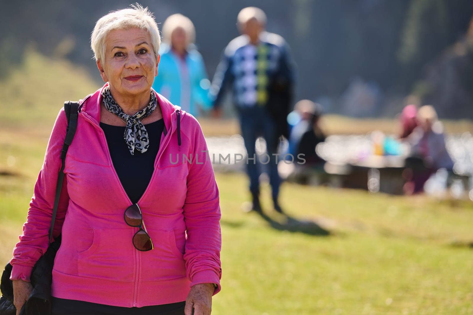 A senior woman finds serenity and wellness as she strolls through nature, illustrating the beauty of maintaining an active and health-conscious lifestyle in her golden years.