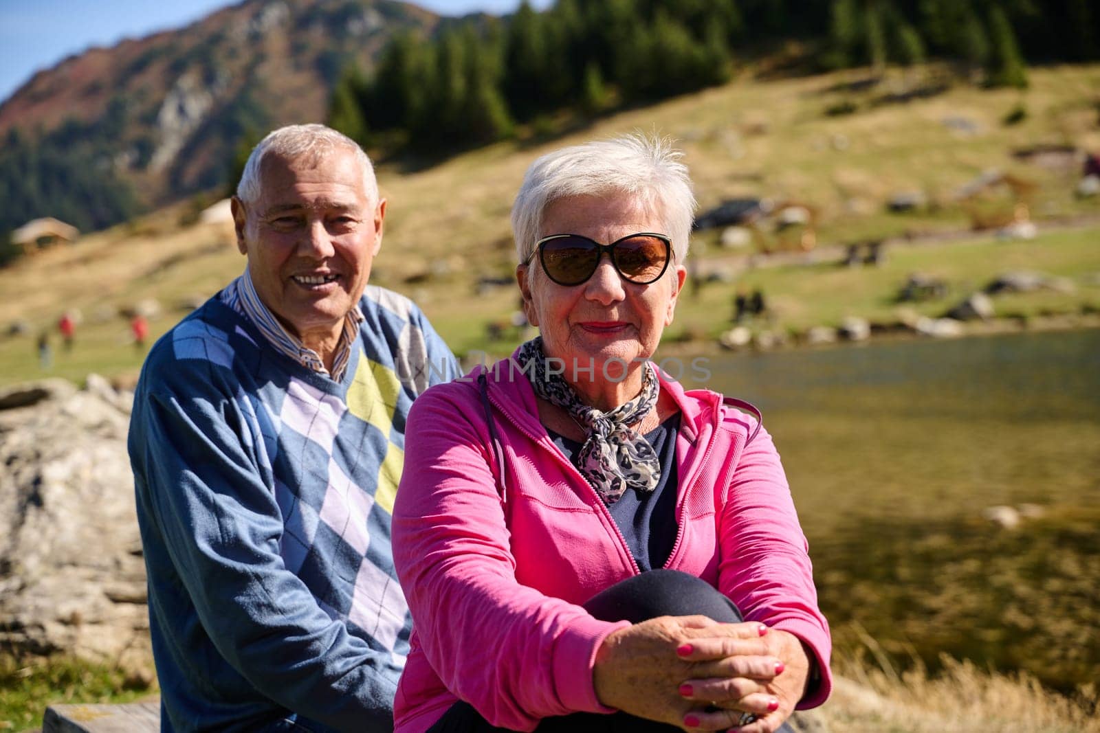 Elderly couple finding solace and joy as they rest on a park bench, engaged in heartfelt conversation, following a rejuvenating strol a testament to the enduring companionship and serene connection that accompanies the golden years by dotshock