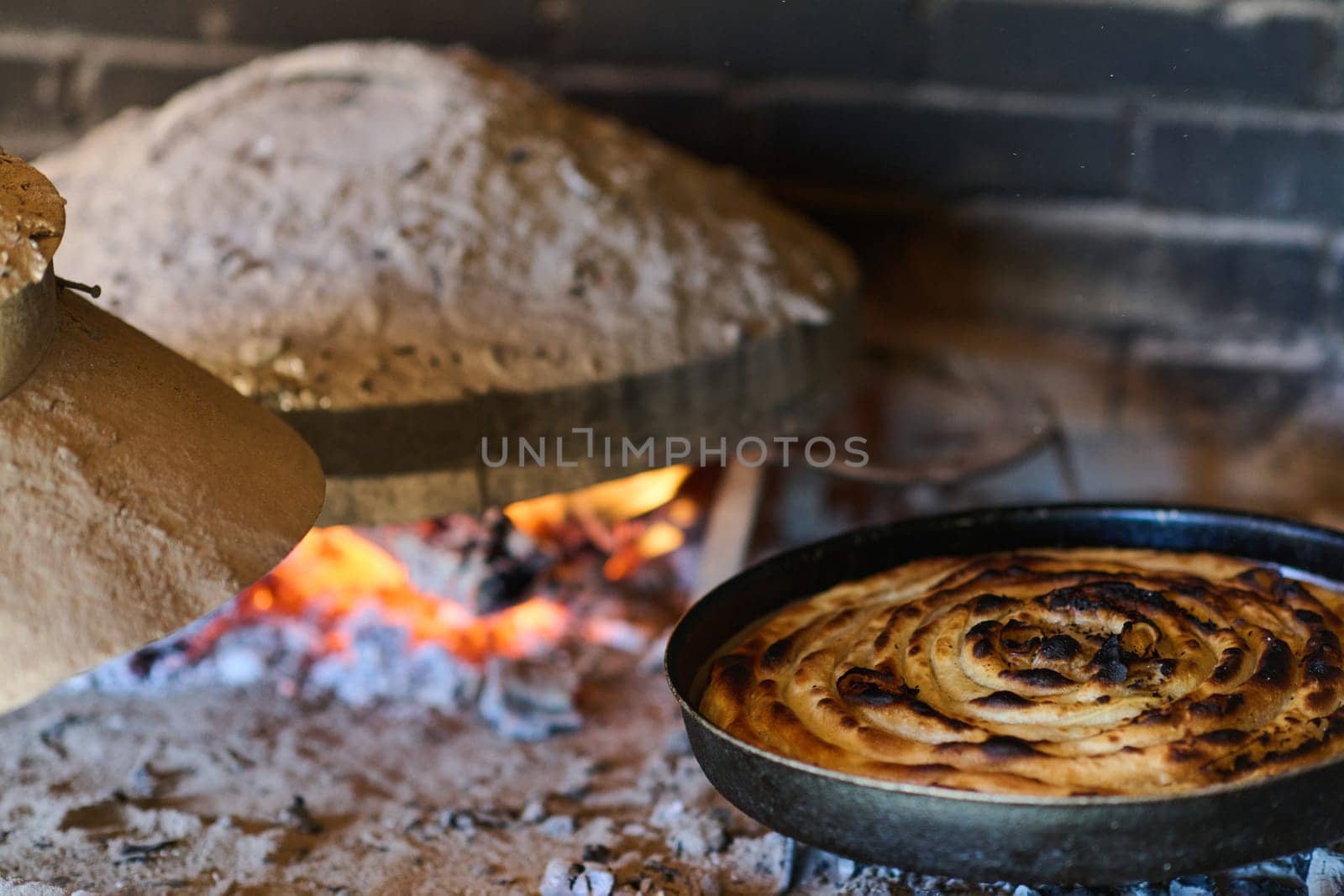 Capturing the essence of Bosnian culinary tradition, step-by-step preparation of a traditional Bosnian pie, showcasing the meticulous craftsmanship and authentic flavors involved in the culinary journey.
