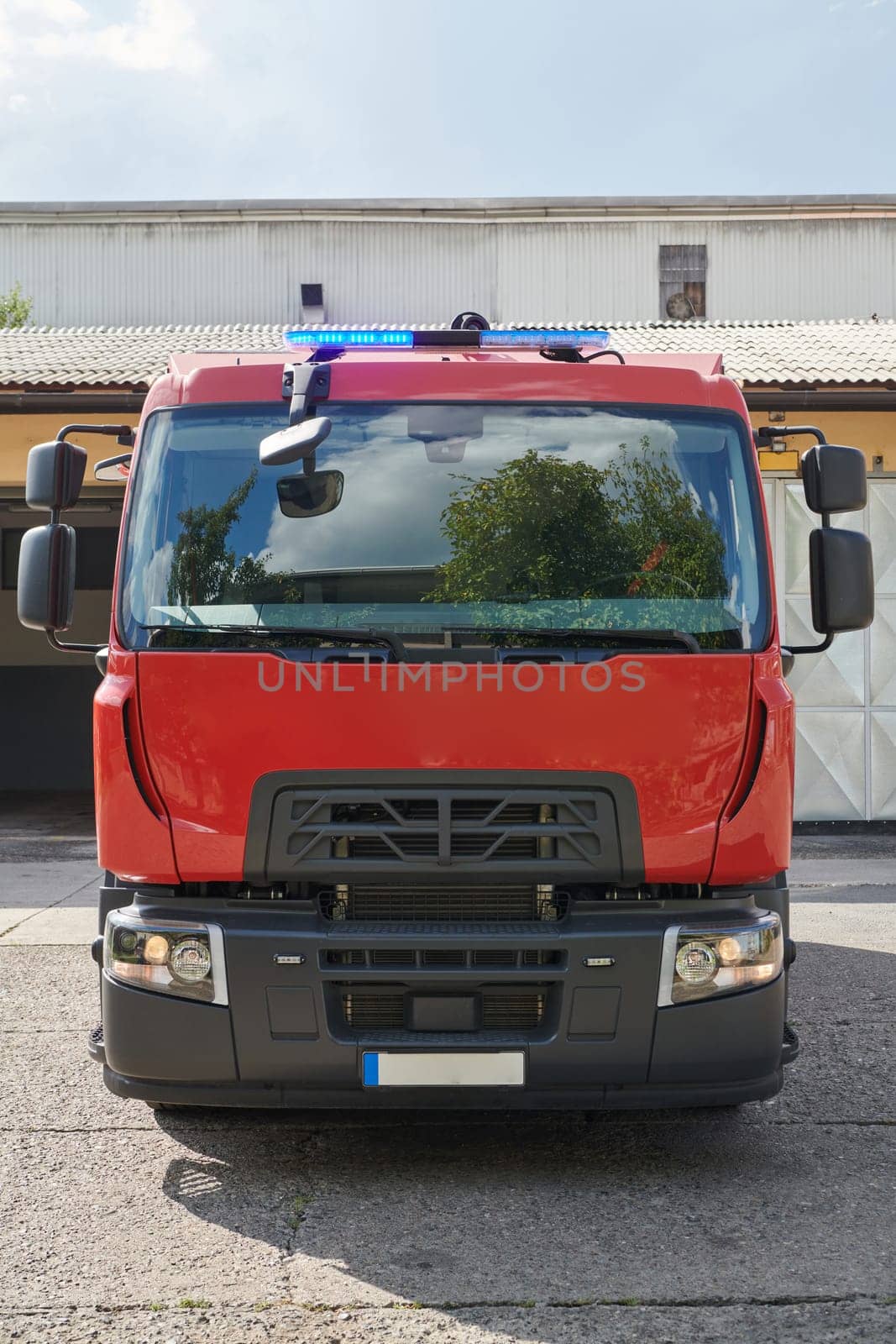 A state-of-the-art firetruck, equipped with advanced rescue technology, stands ready with its skilled firefighting team, prepared to intervene and respond rapidly to emergencies, ensuring the safety and protection of the community. High quality photo