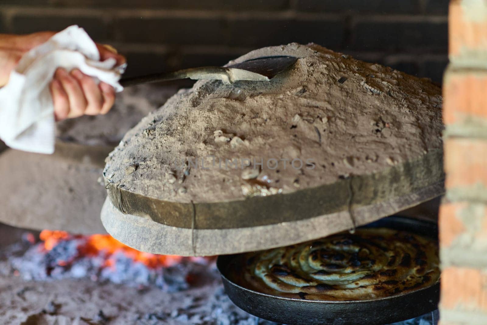 Capturing the essence of Bosnian culinary tradition, step-by-step preparation of a traditional Bosnian pie, showcasing the meticulous craftsmanship and authentic flavors involved in the culinary journey by dotshock