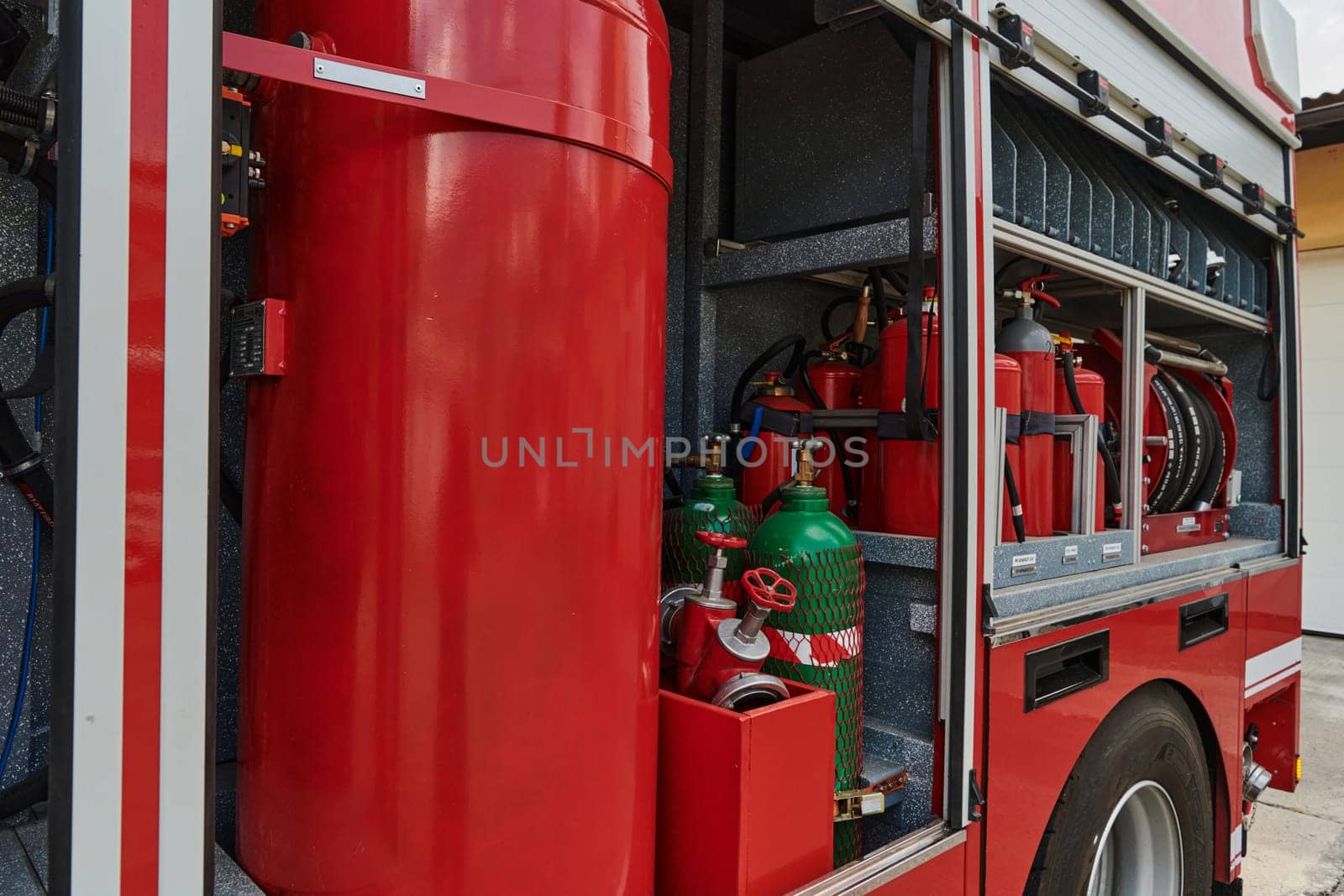 A state-of-the-art firetruck, equipped with advanced rescue technology, stands ready with its skilled firefighting team, prepared to intervene and respond rapidly to emergencies, ensuring the safety and protection of the community. High quality photo