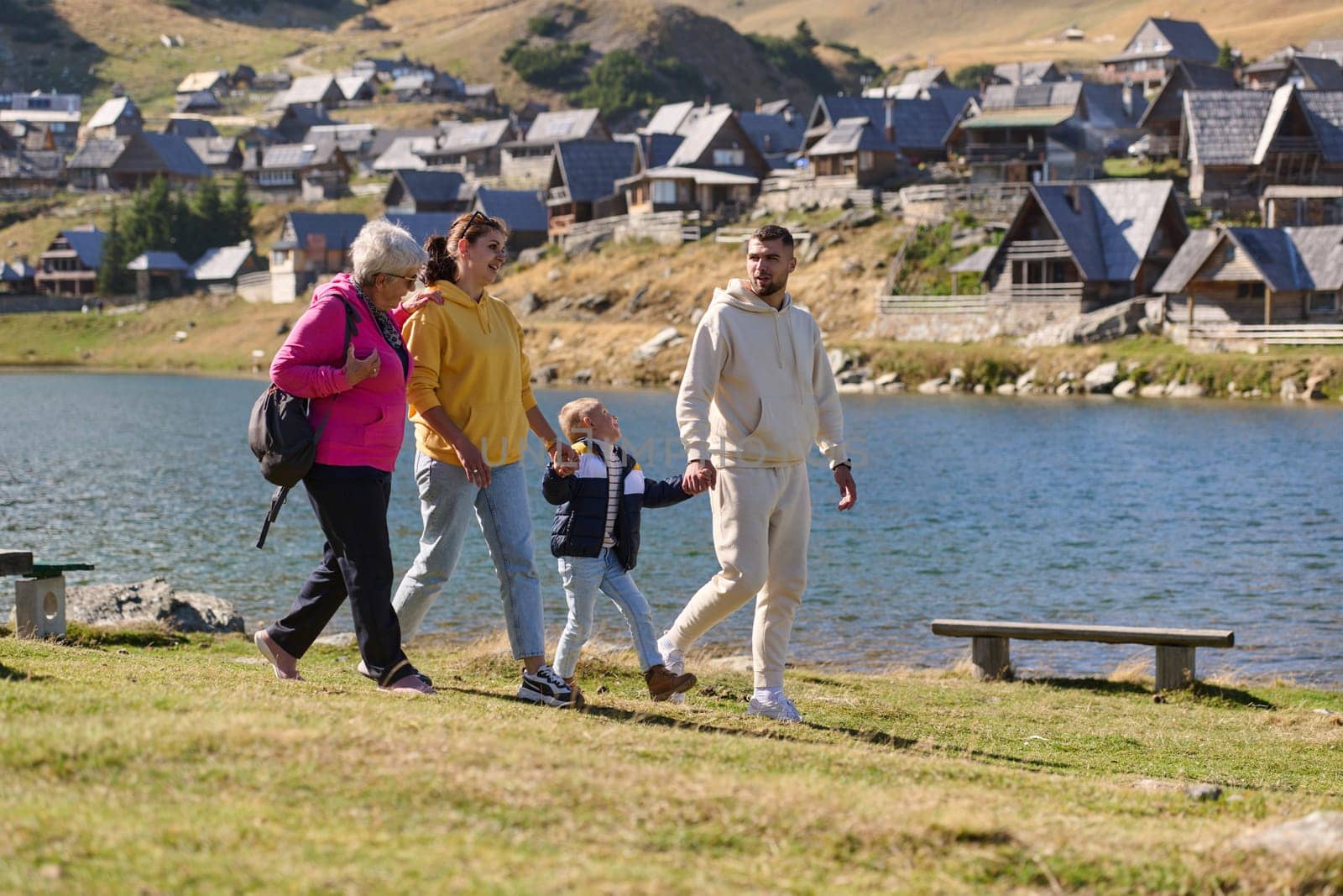 A family shares delightful moments with their friends amid the stunning landscapes of mountains, lakes, and winding paths, promoting a healthy lifestyle and the joy of familial bonds in the embrace of nature's beauty.