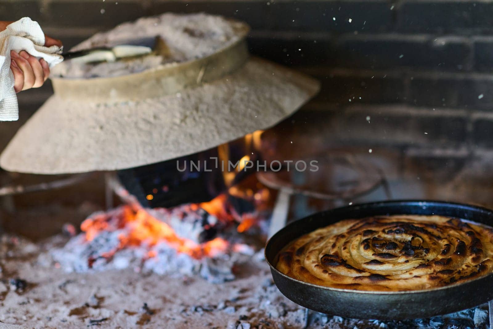 Capturing the essence of Bosnian culinary tradition, step-by-step preparation of a traditional Bosnian pie, showcasing the meticulous craftsmanship and authentic flavors involved in the culinary journey by dotshock