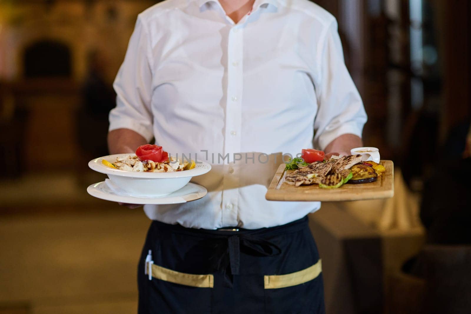 A courteous waiter provides impeccable service to an elderly family and their friends, creating a convivial atmosphere as they gather for a shared lunch, indulging in the diverse and delectable offerings of the contemporary culinary experience.