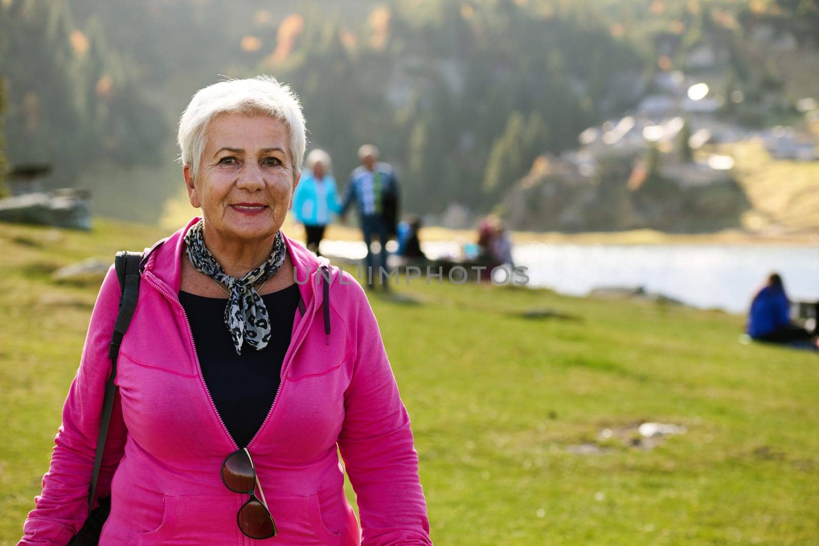 A senior woman finds serenity and wellness as she strolls through nature, illustrating the beauty of maintaining an active and health-conscious lifestyle in her golden years.