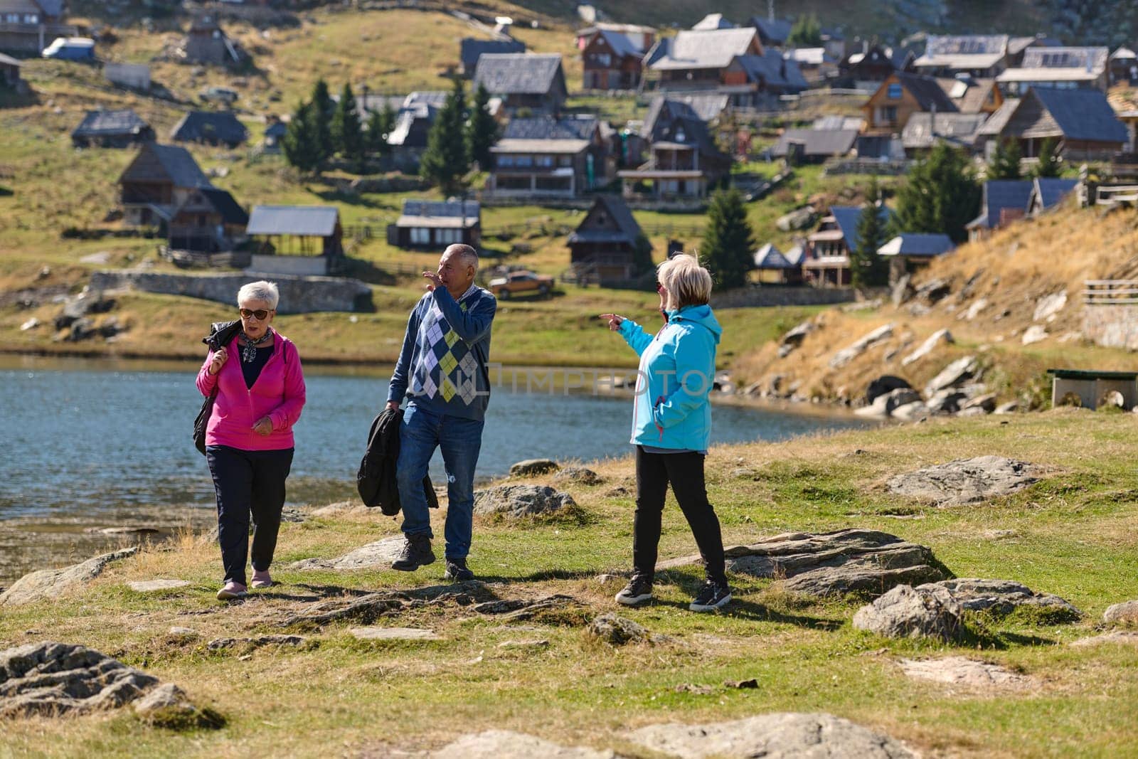 A family shares delightful moments with their friends amid the stunning landscapes of mountains, lakes, and winding paths, promoting a healthy lifestyle and the joy of familial bonds in the embrace of nature's beauty.