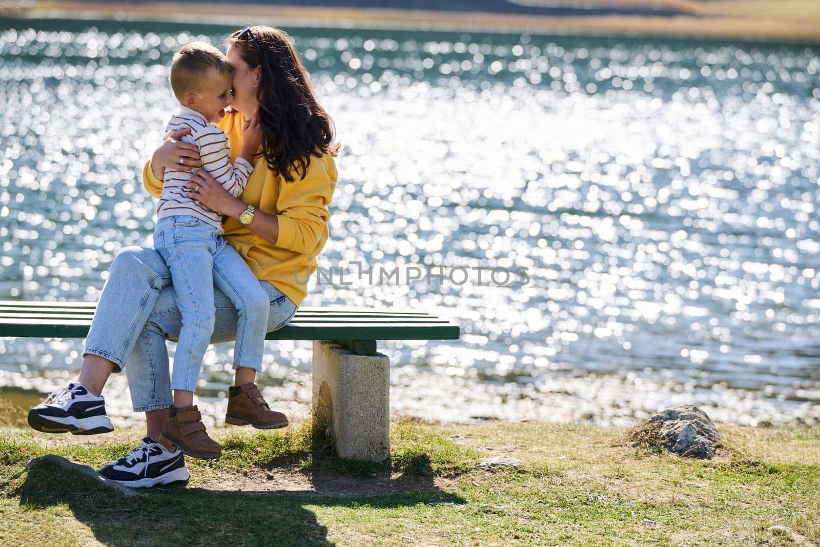 A mother and son create cherished memories as they playfully engage in outdoor activities, their laughter echoing the joy of shared moments and the bond between parent and child.