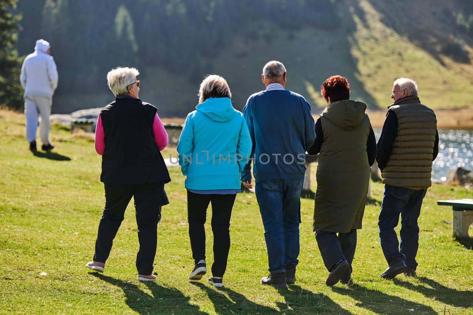 A family shares delightful moments with their friends amid the stunning landscapes of mountains, lakes, and winding paths, promoting a healthy lifestyle and the joy of familial bonds in the embrace of nature's beauty.