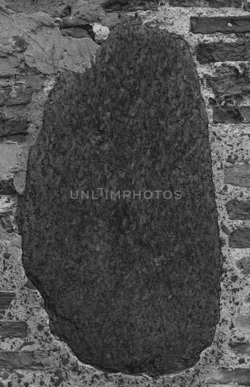 Vertical photo of a wall made of brick and large stone. by gelog67