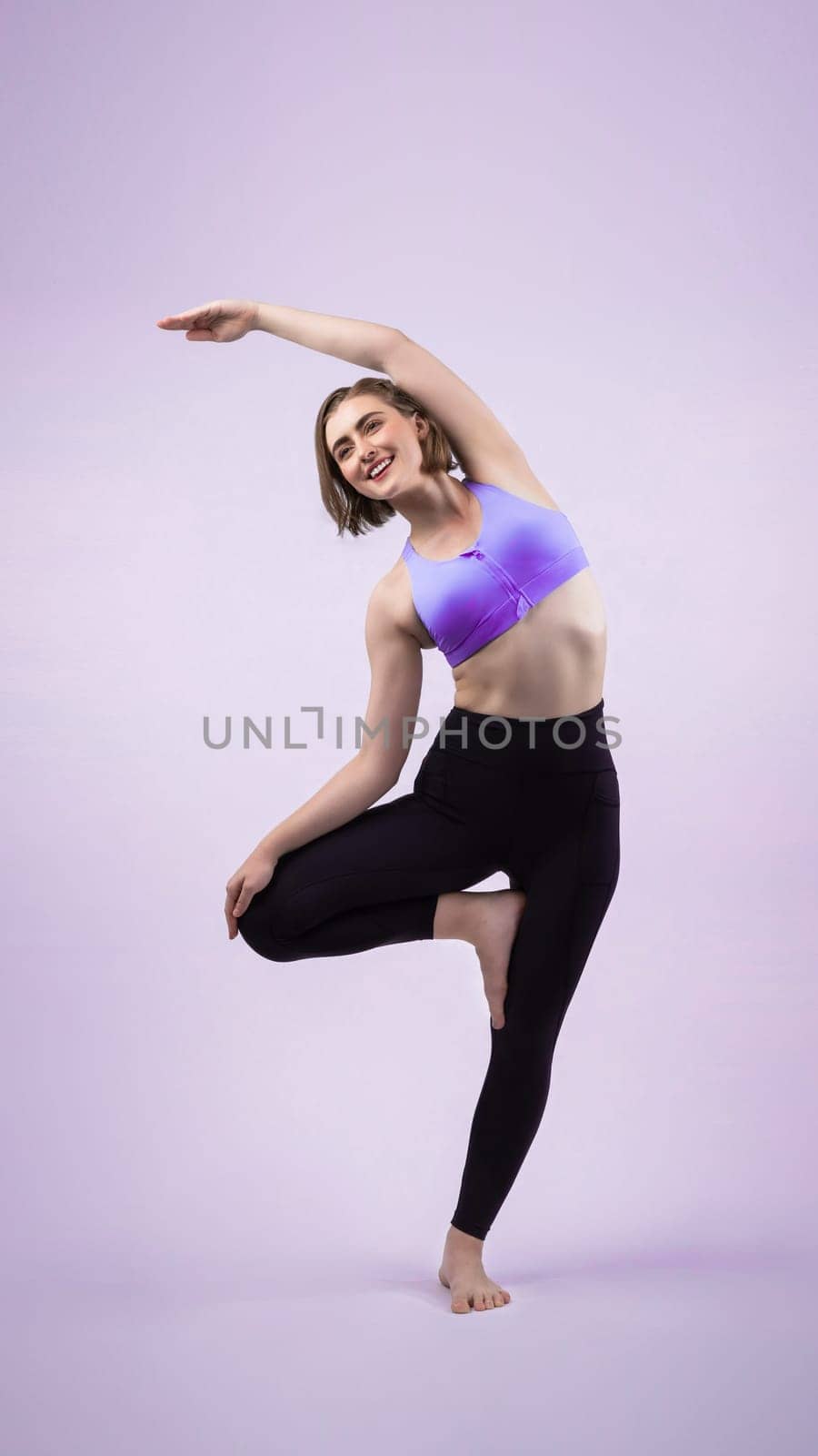 Full body length gaiety shot athletic and sporty woman doing yoga by biancoblue