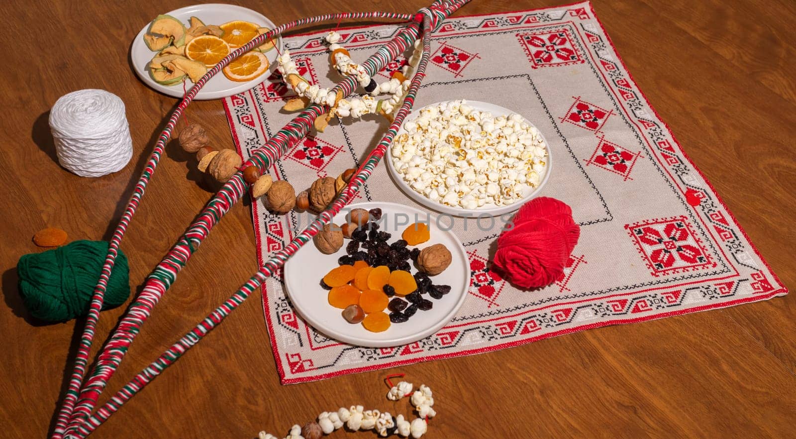 Flatly Survakane, Survachka On Table. Bulgarian Traditional Cornel Stick With Decorations, Dried Fruits, Threads, Popcorn. Christmas Entertainment. Horizontal Plane. Survakarcheta
