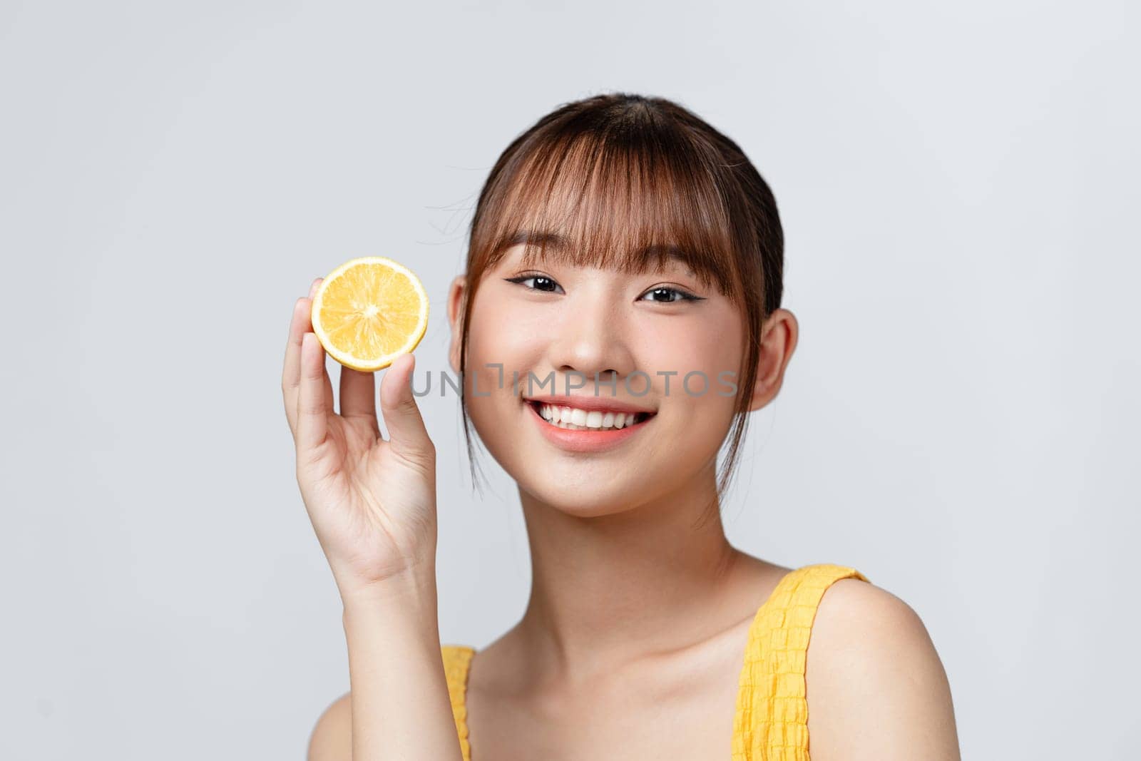 Energy. Close up of beautiful young woman with lemon slices on white background. by makidotvn