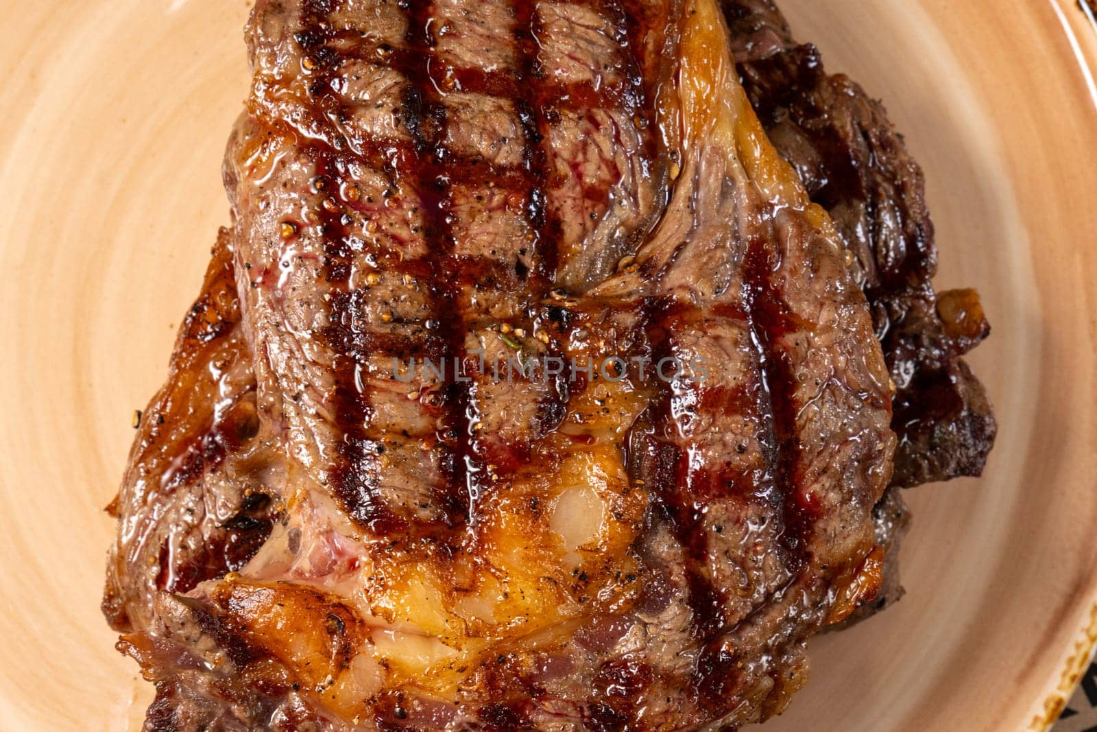 Grilled steak presented on plate, highlighting the rich caramelization and irresistible char marks.