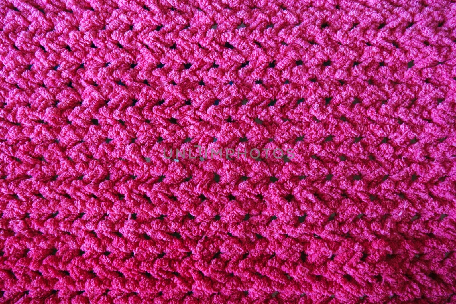 Close-Up of an Intricately Textured Pink Crocheted Blanket by darksoul72