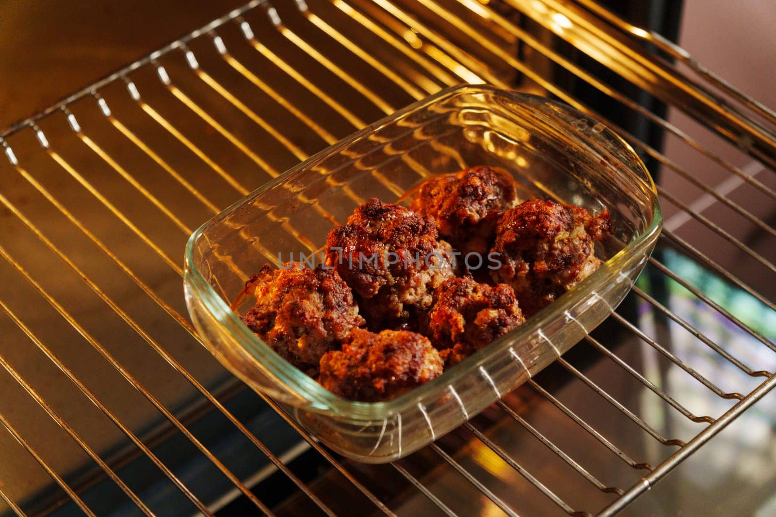 Meatballs with a succulent and crispy exterior rest in a glass baking dish, embodying the warmth of a home-cooked meal. by darksoul72