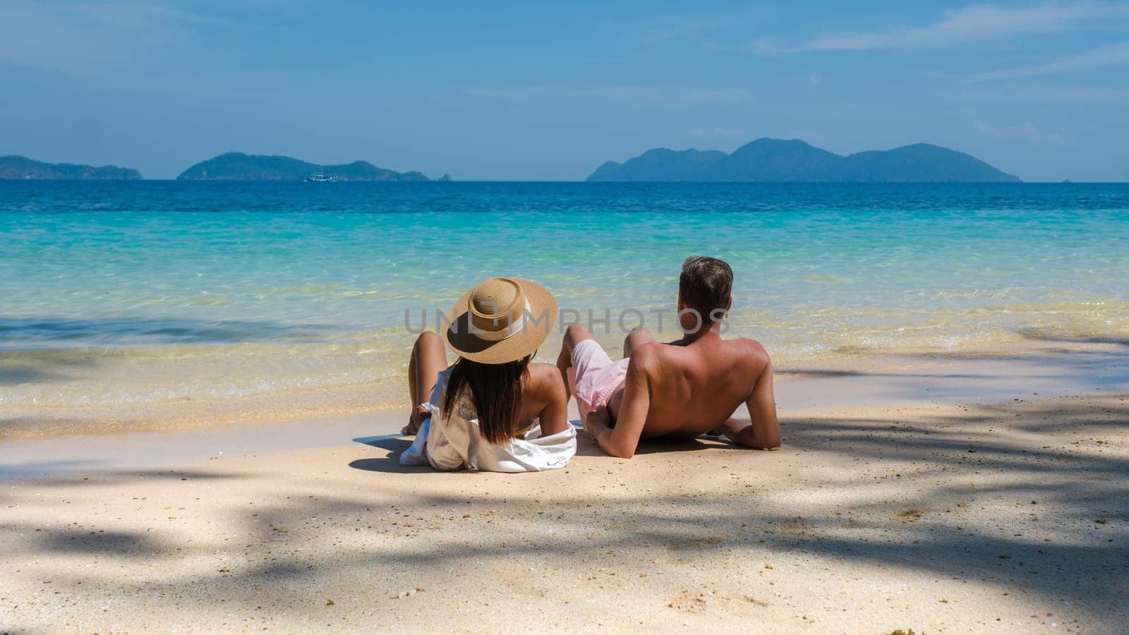 Koh Wai Island Trat Thailand is a tinny tropical Island near Koh Chang. a young couple of men and women on a tropical beach during a luxury vacation in Thailand relaxing on the beach