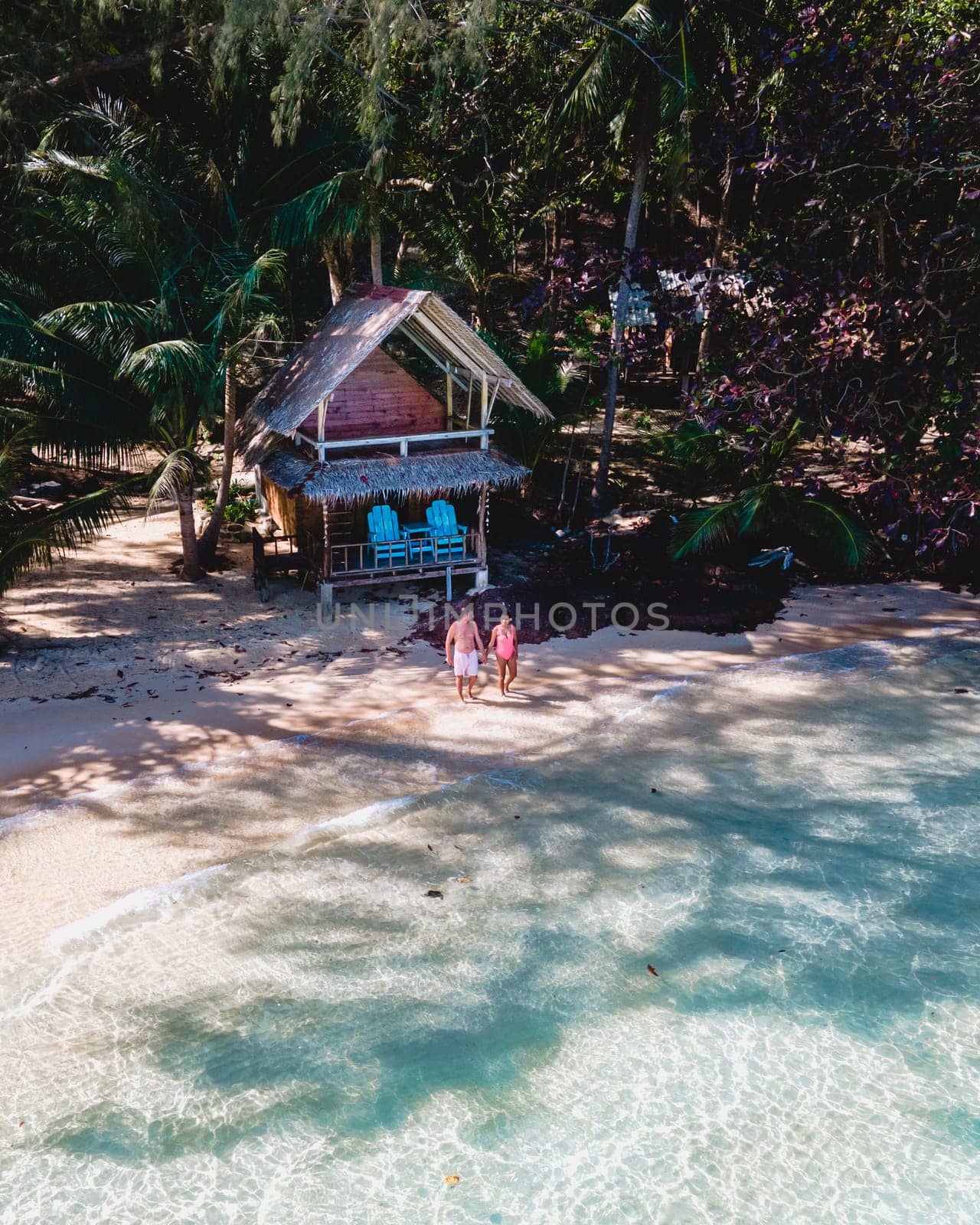 Wooden bamboo hut bungalow on the beach. a young couple of men and woman on a tropical Island in Thailand, Koh Wai Island Trat Thailand