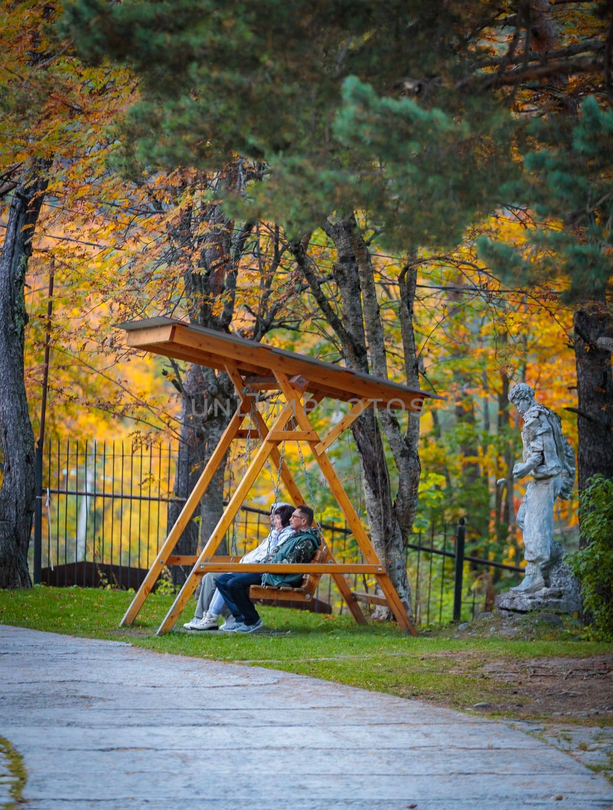 Couple on bench in autumn bright park by Yurich32