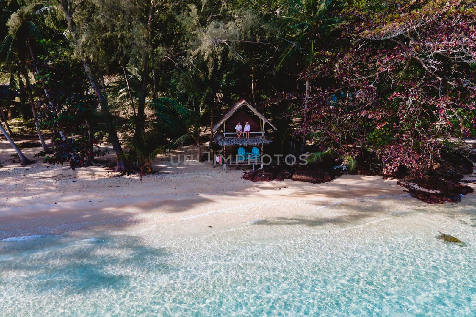 Koh Wai Island Trat Thailand. wooden bamboo hut bungalow on the beach. a young couple of men and woman on a tropical Island in Thailand