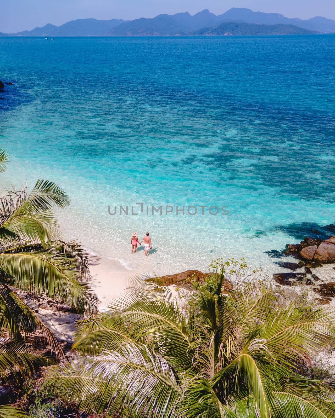 Koh Wai Island Thailand tropical Island near Koh Chang, couple of men and woman on the beach by fokkebok