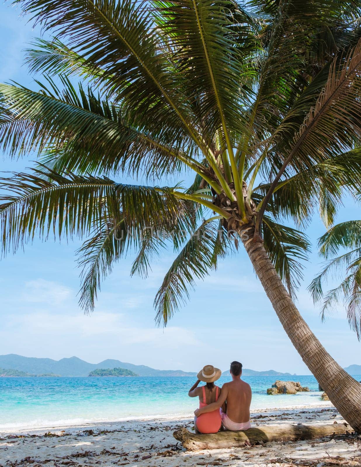 Koh Wai Island Thailand tropical Island near Koh Chang, couple of men and woman on the beach by fokkebok