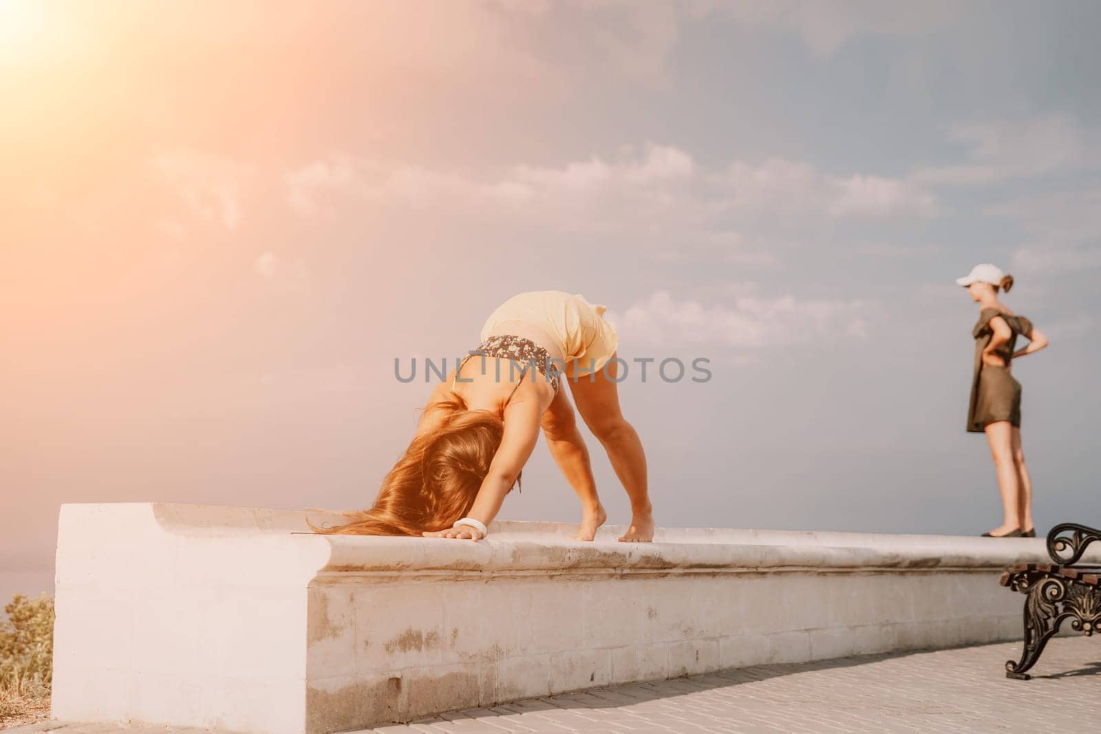 Woman park yoga. Side view of free calm bliss satisfied woman with long hair standing in morning park with yoga position against of sky by the sea. Healthy lifestyle outdoors in park, fitness concept. by panophotograph