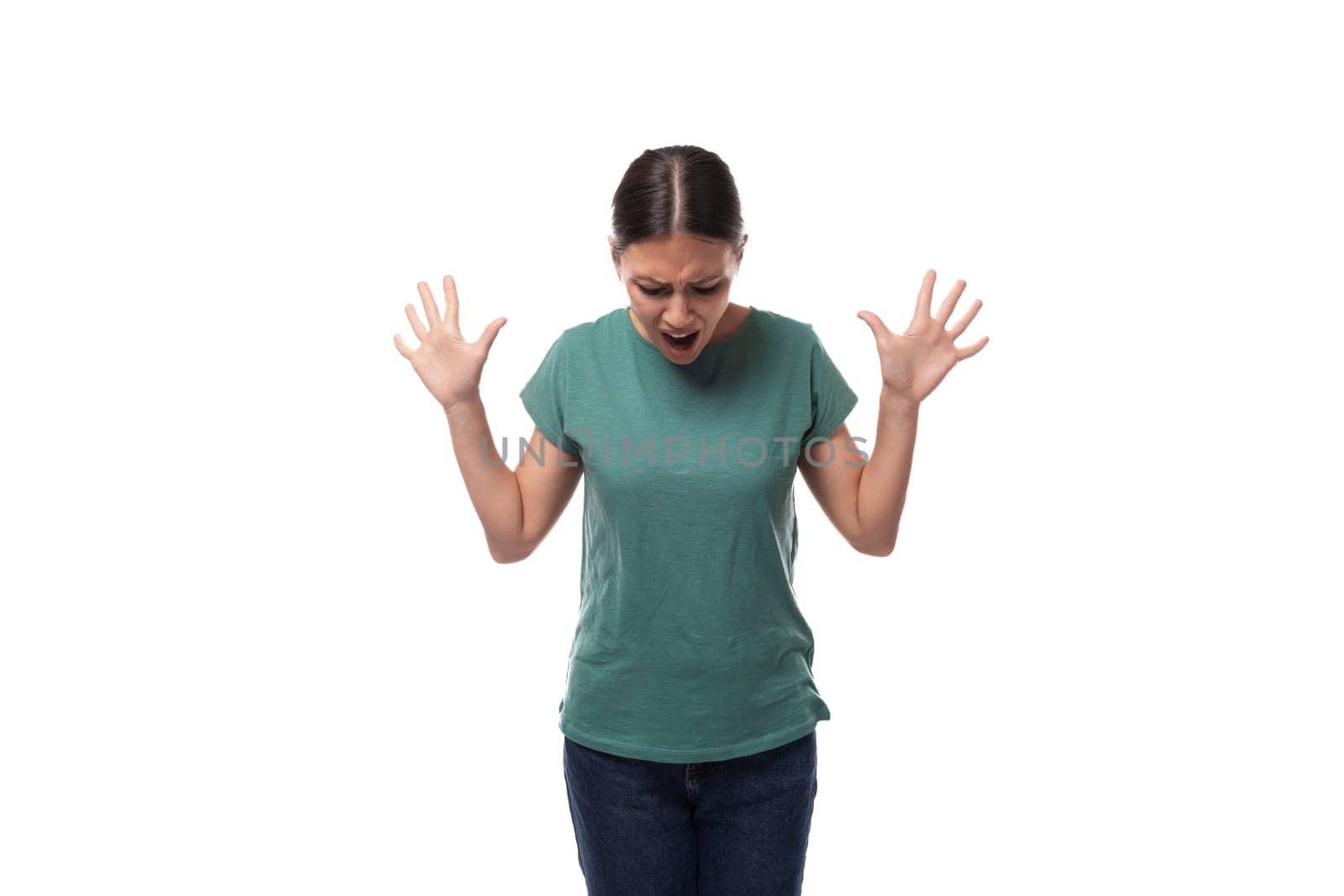 young slender woman dressed in a green basic t-shirt with a mockup looks confused by TRMK