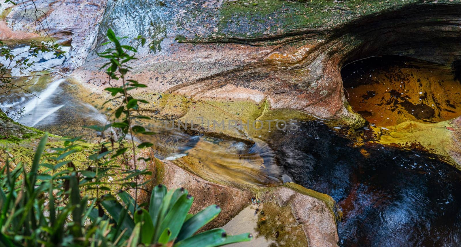 Colorful Rock Formations with Flowing Water in Nature by FerradalFCG