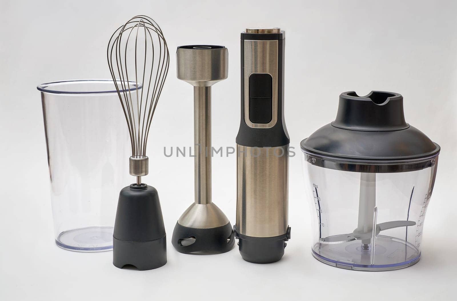 Immersion hand blender with various attachments and two cups. Electric kitchen appliances for making sauces, smoothies, purees. Hand mixer set.