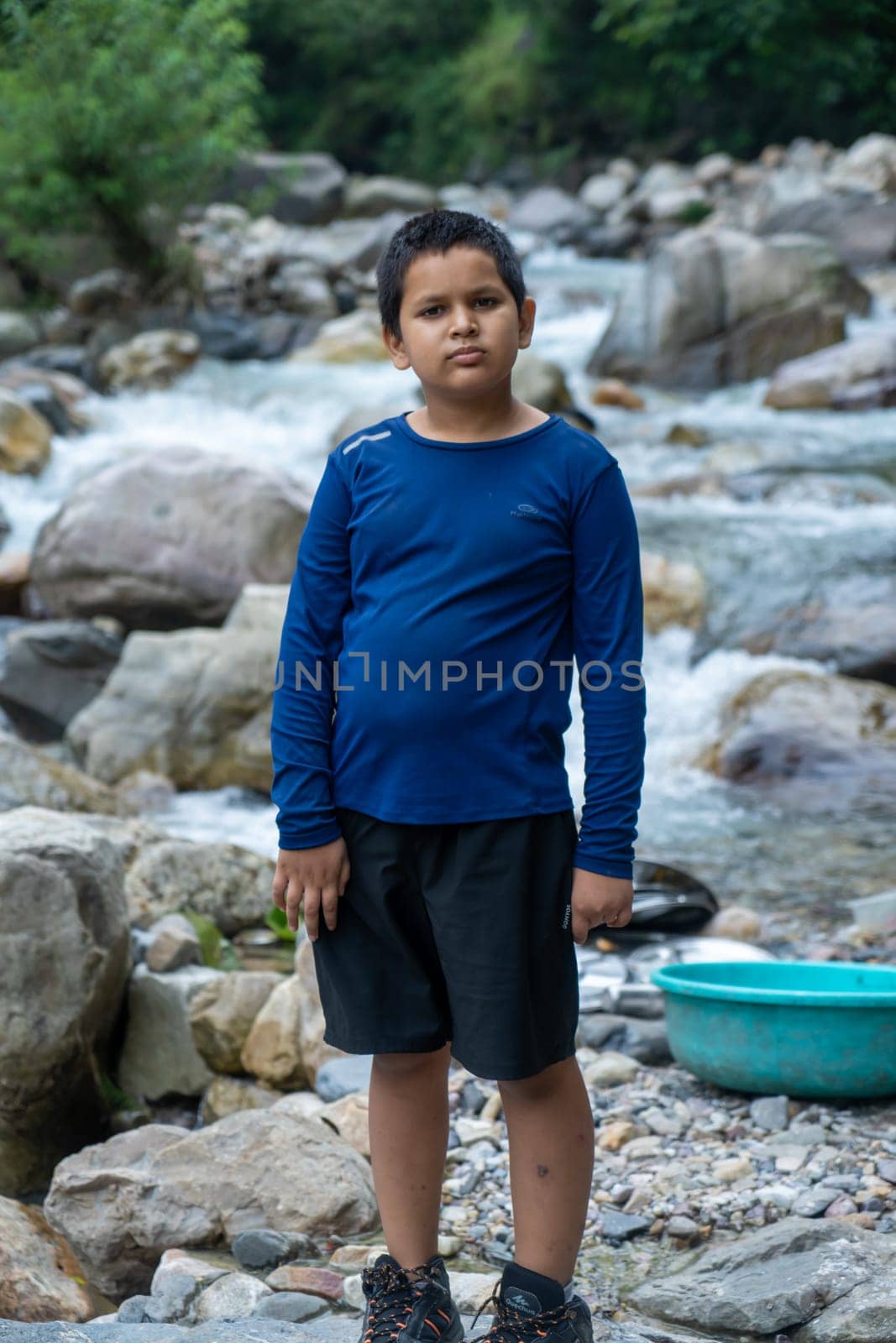 A boy stands, absorbing the rhythm of nature's timeless flow.