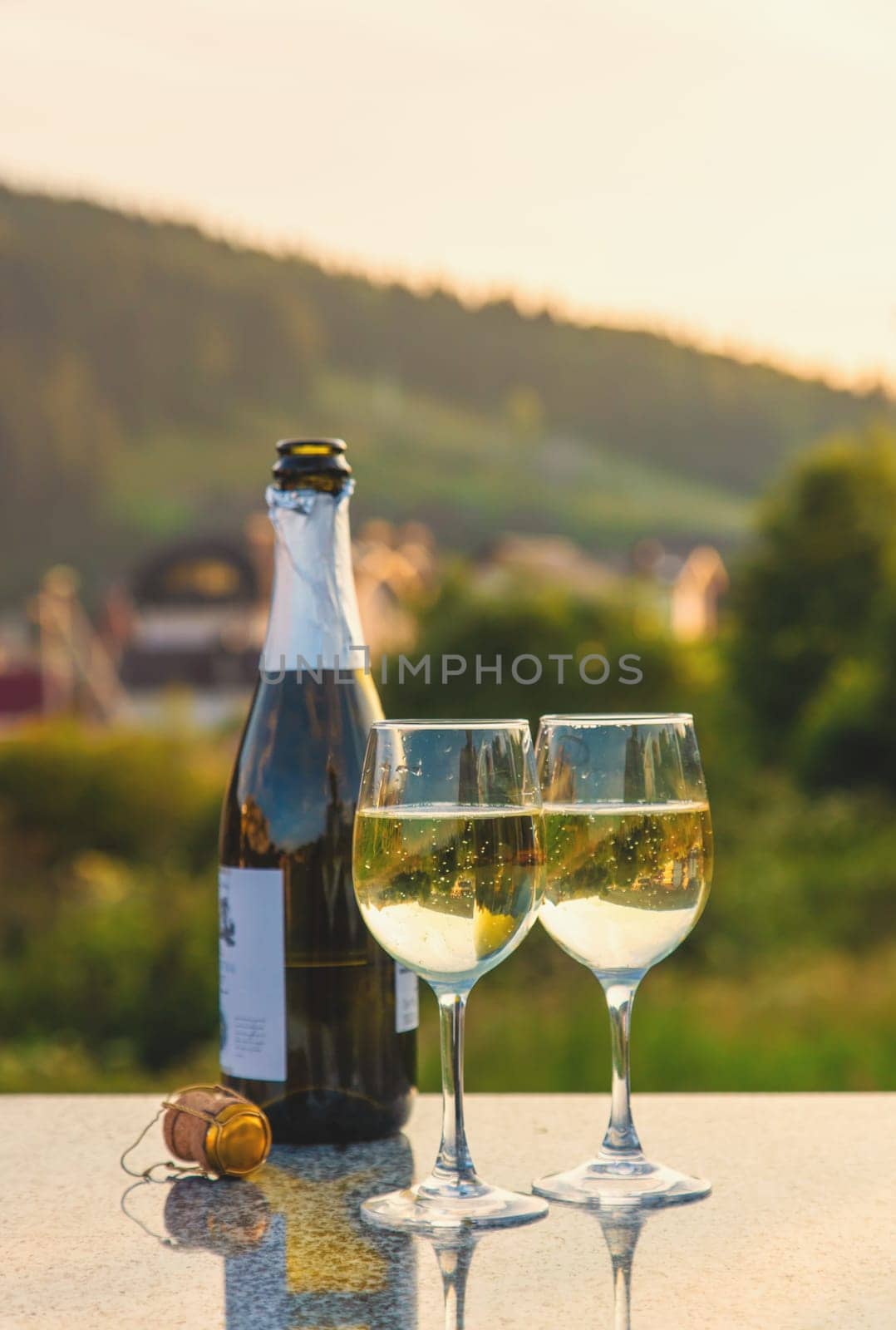 Glasses of wine against the background of mountains. Selective focus. by yanadjana