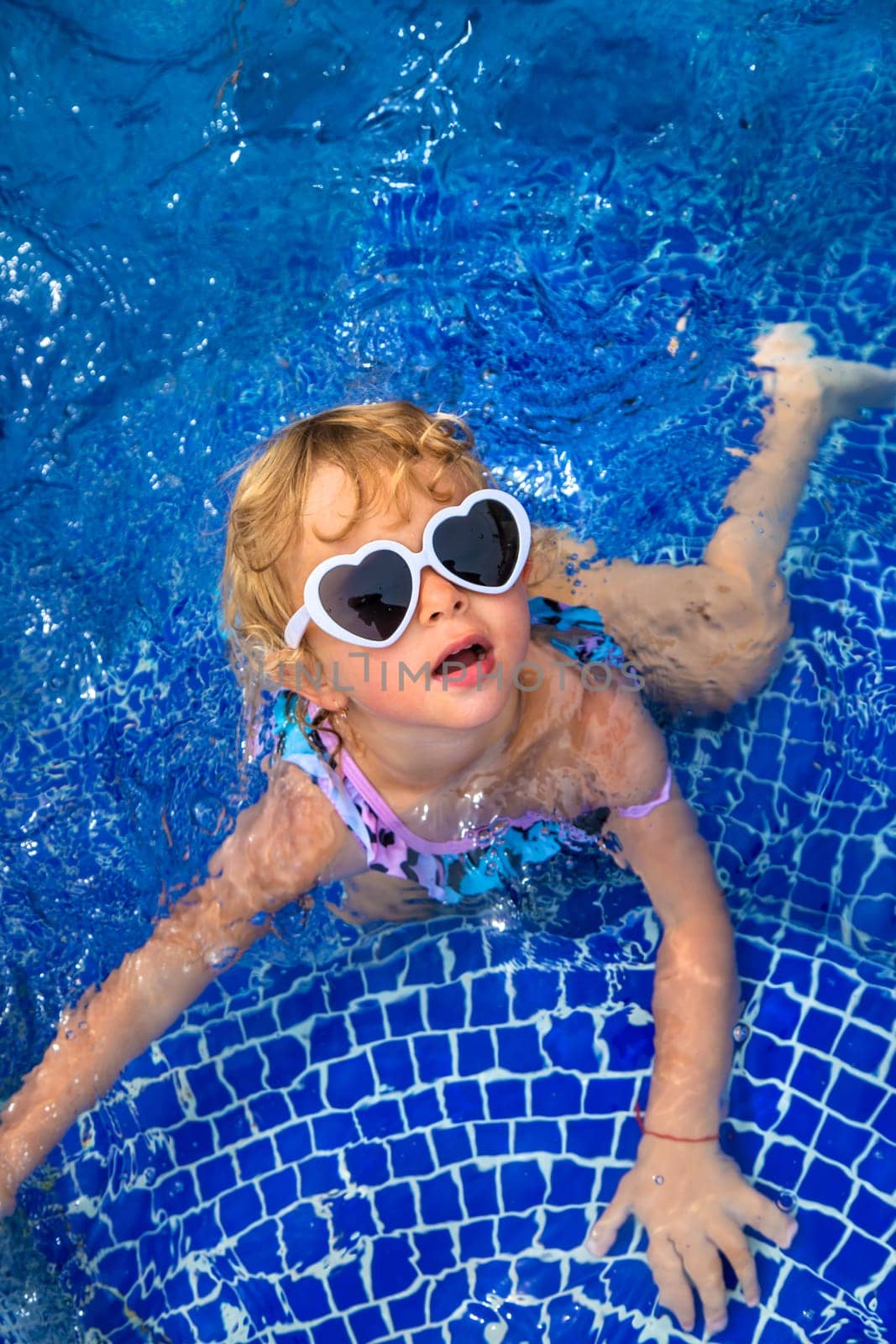 A child swims in the pool. Selective focus. by yanadjana