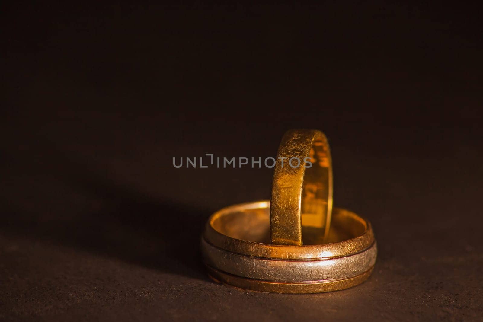 The well worn wedding bands of a couple celebrating many decades of marraige