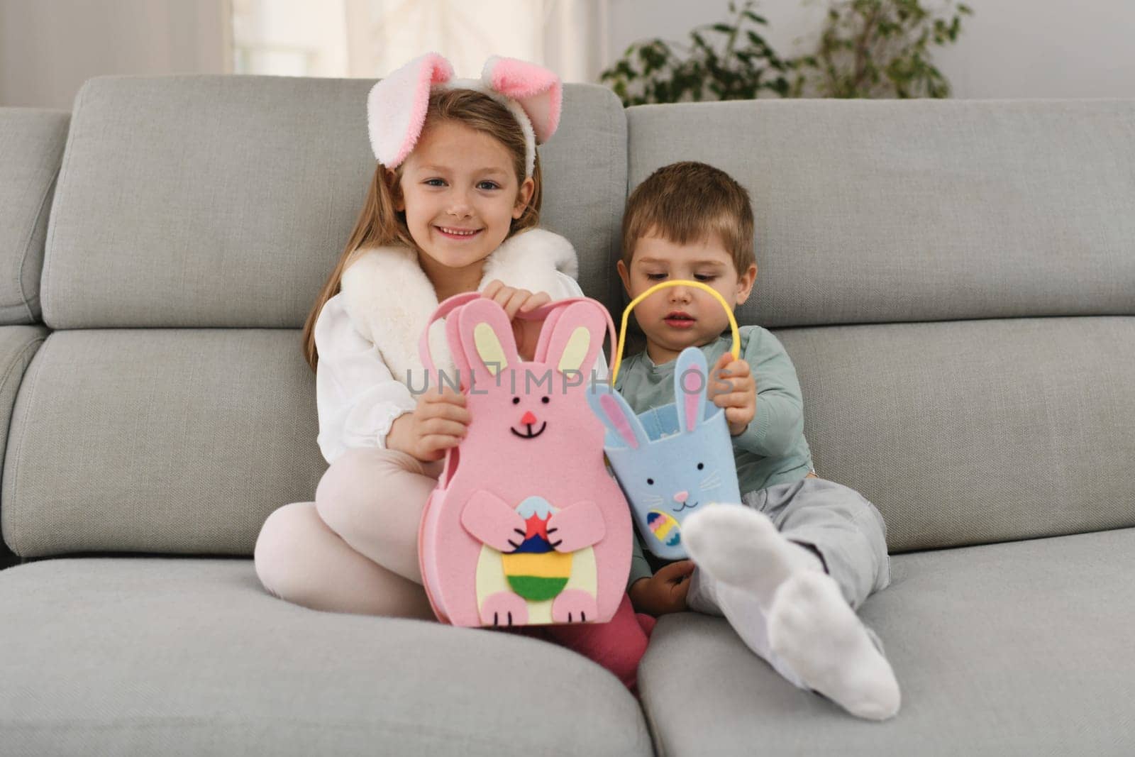 Children with bunny ears and basket for chocolate eggs Easter by Godi