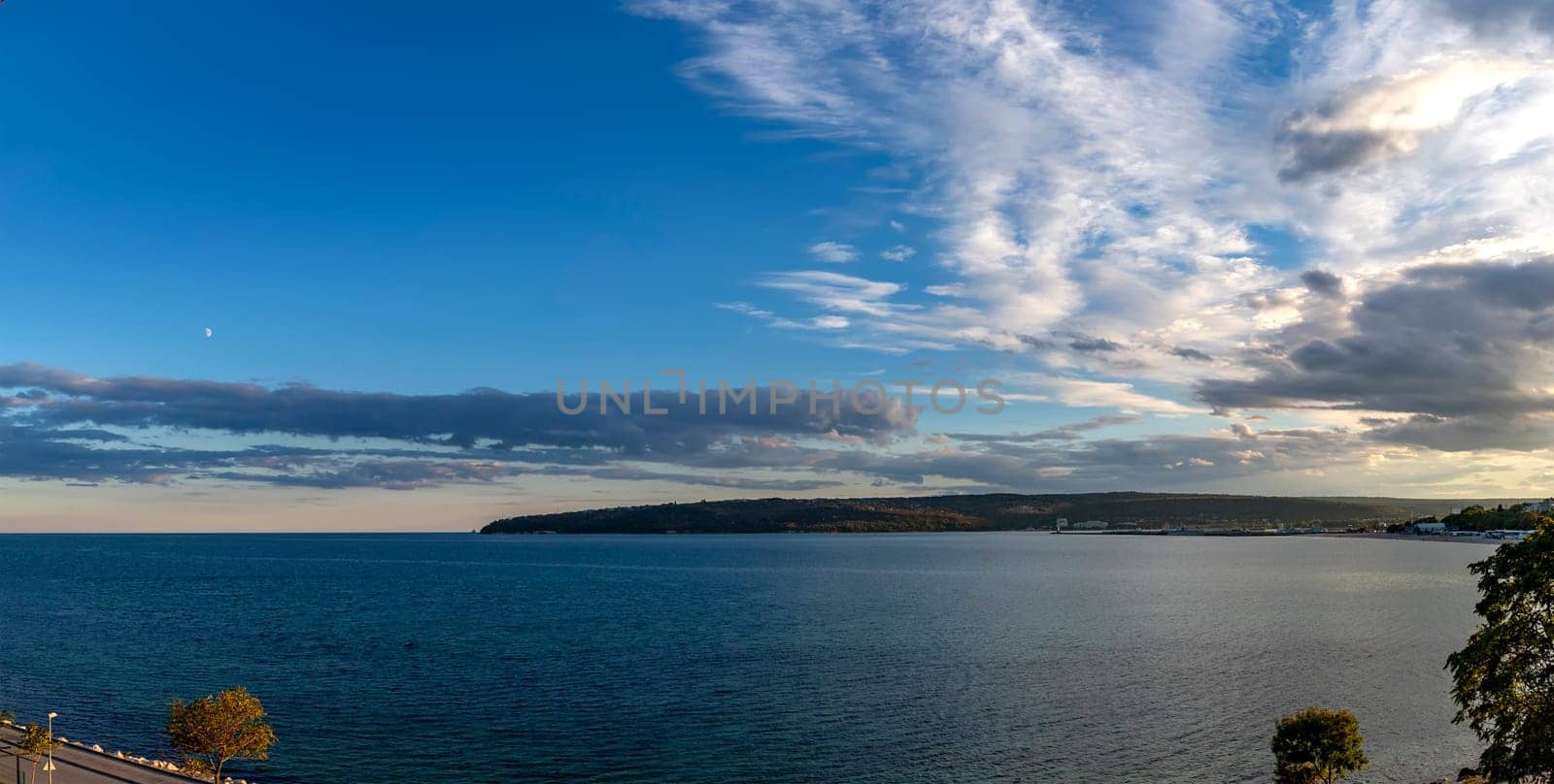 Panoramic view at sea bay and cloudy sunset sky. by EdVal