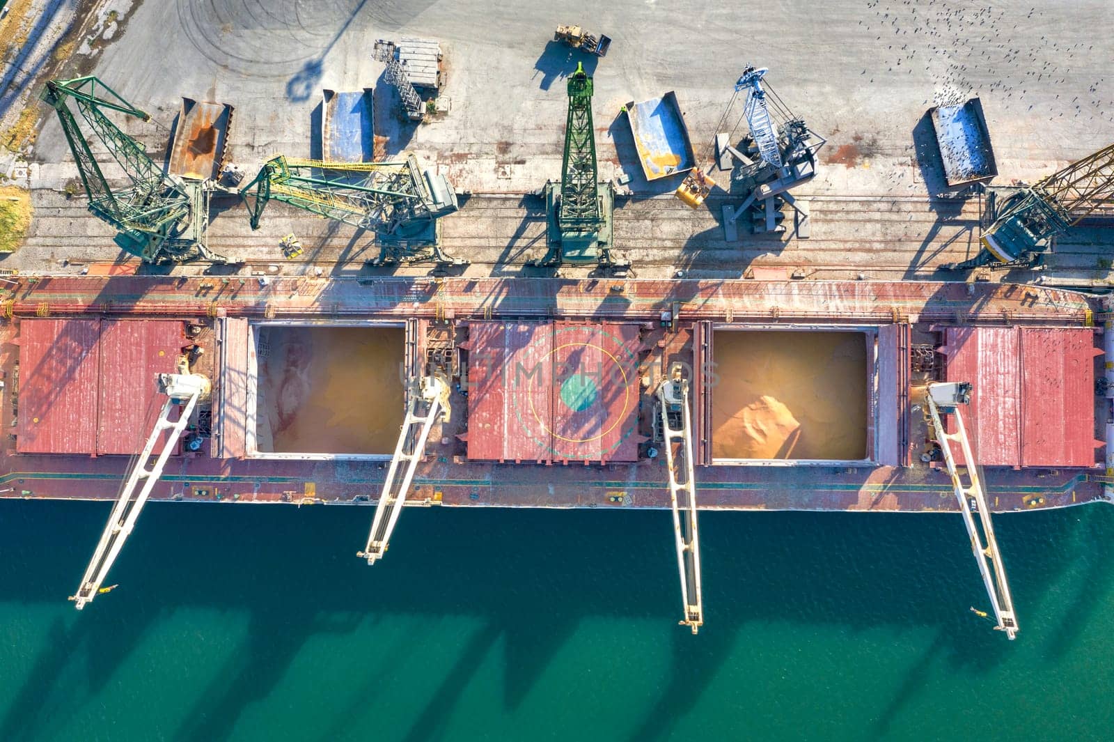 Top view from a drone of a large ship loading grain for export. Water transport  by EdVal