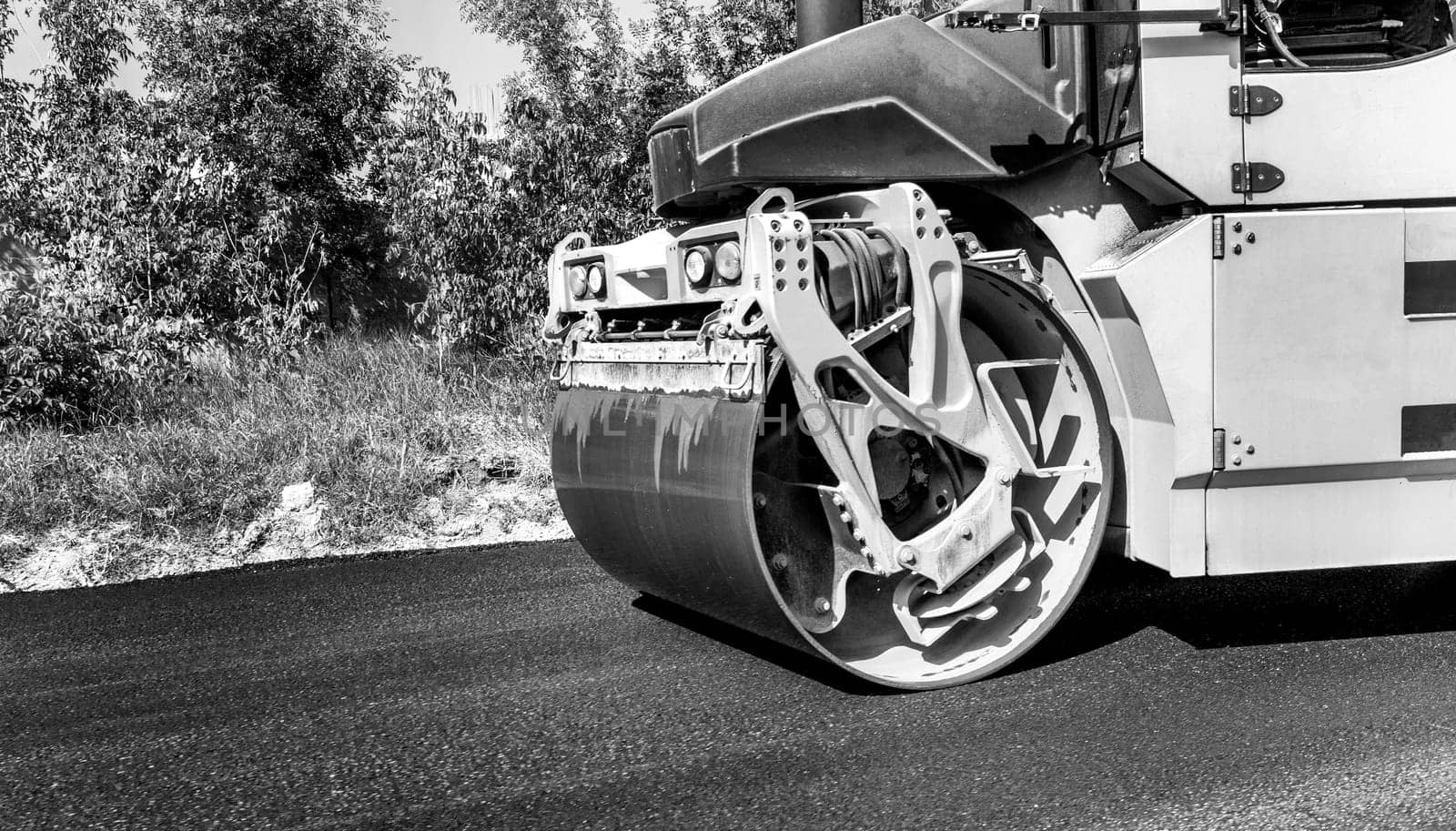 Close view of drum roller at the construction site, working on the new road  by EdVal