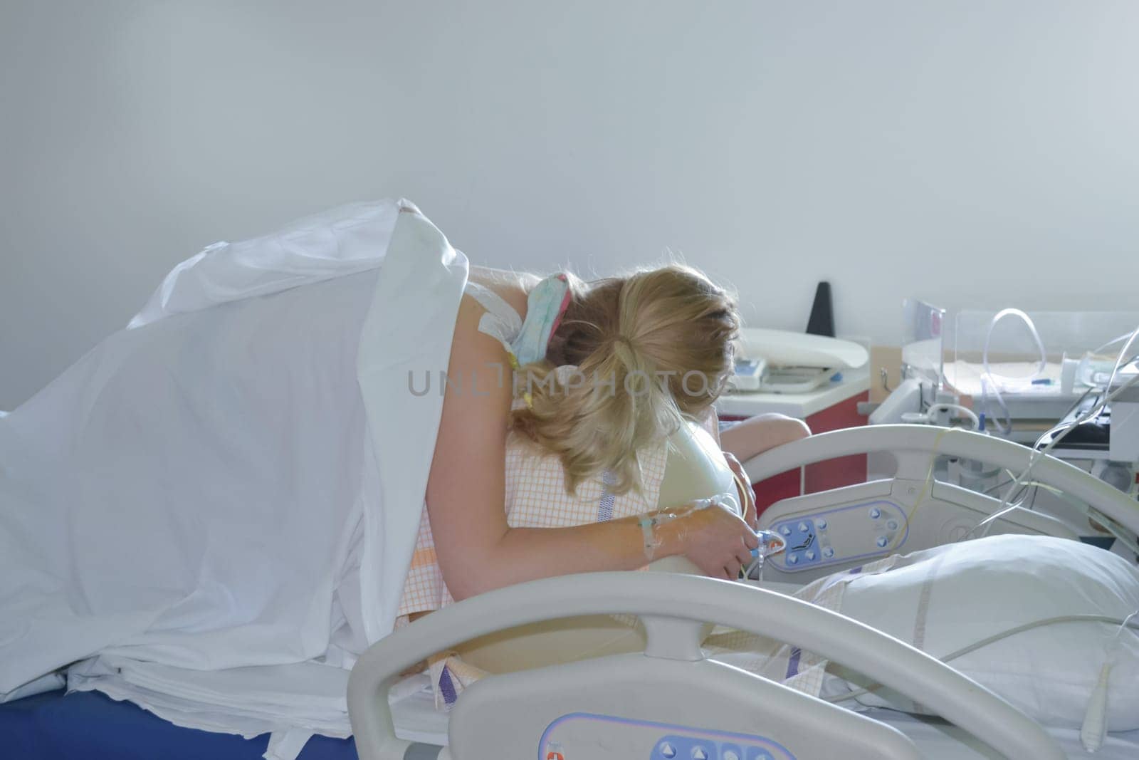 Woman during contractions on a fitness ball Parturition hospital