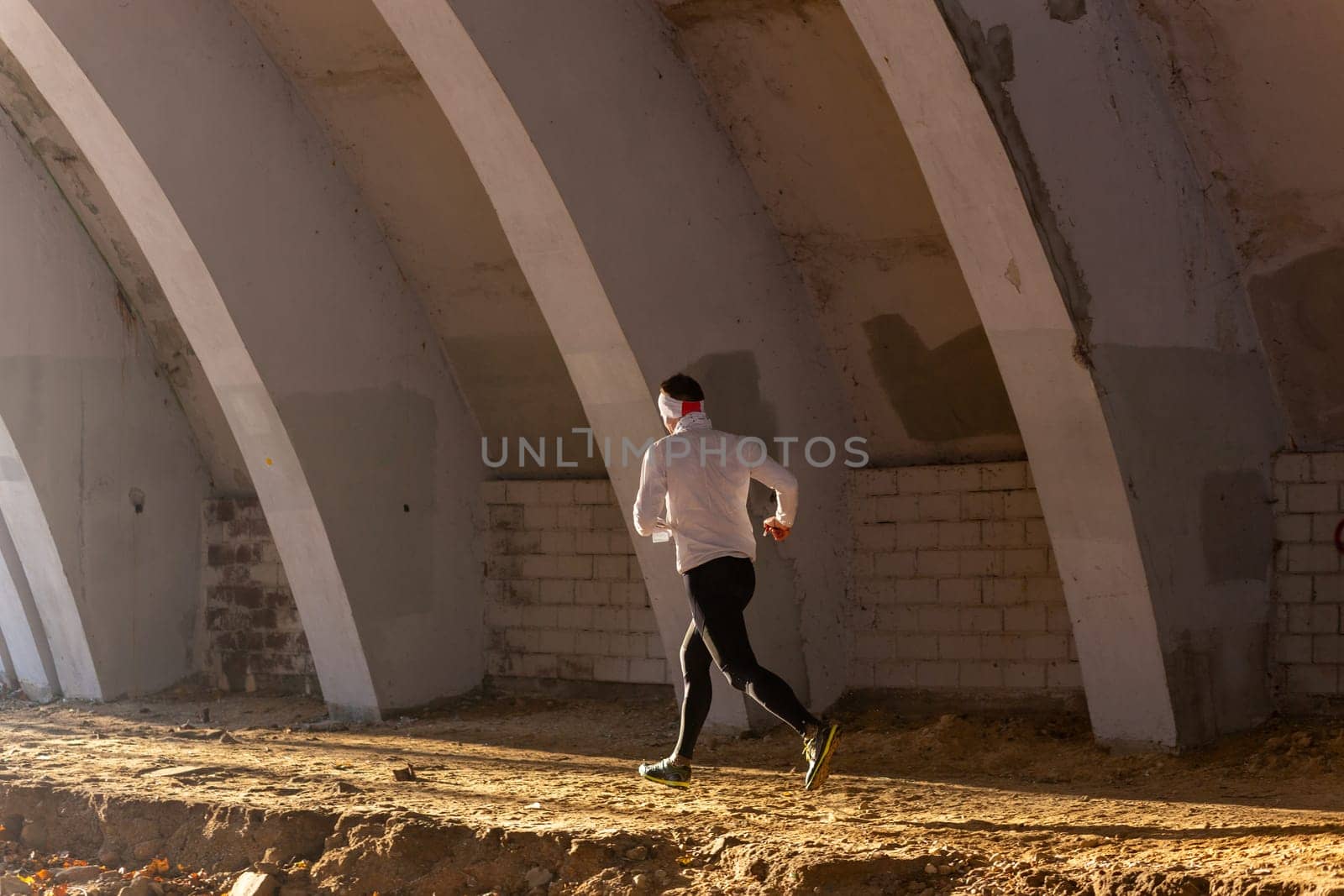 Young man participates in winter orienteering training in urban conditions. Outdoor orienteering check point activity