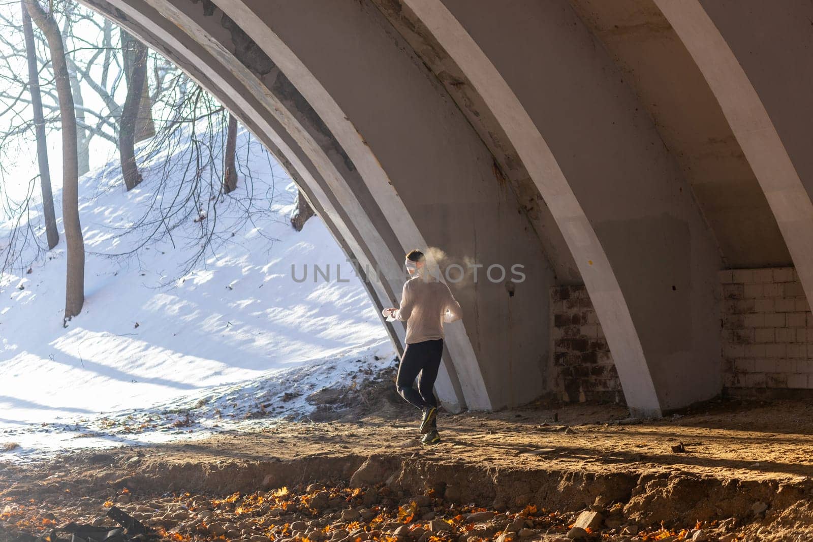 Young man participates in winter orienteering training in urban conditions. Outdoor orienteering check point activity