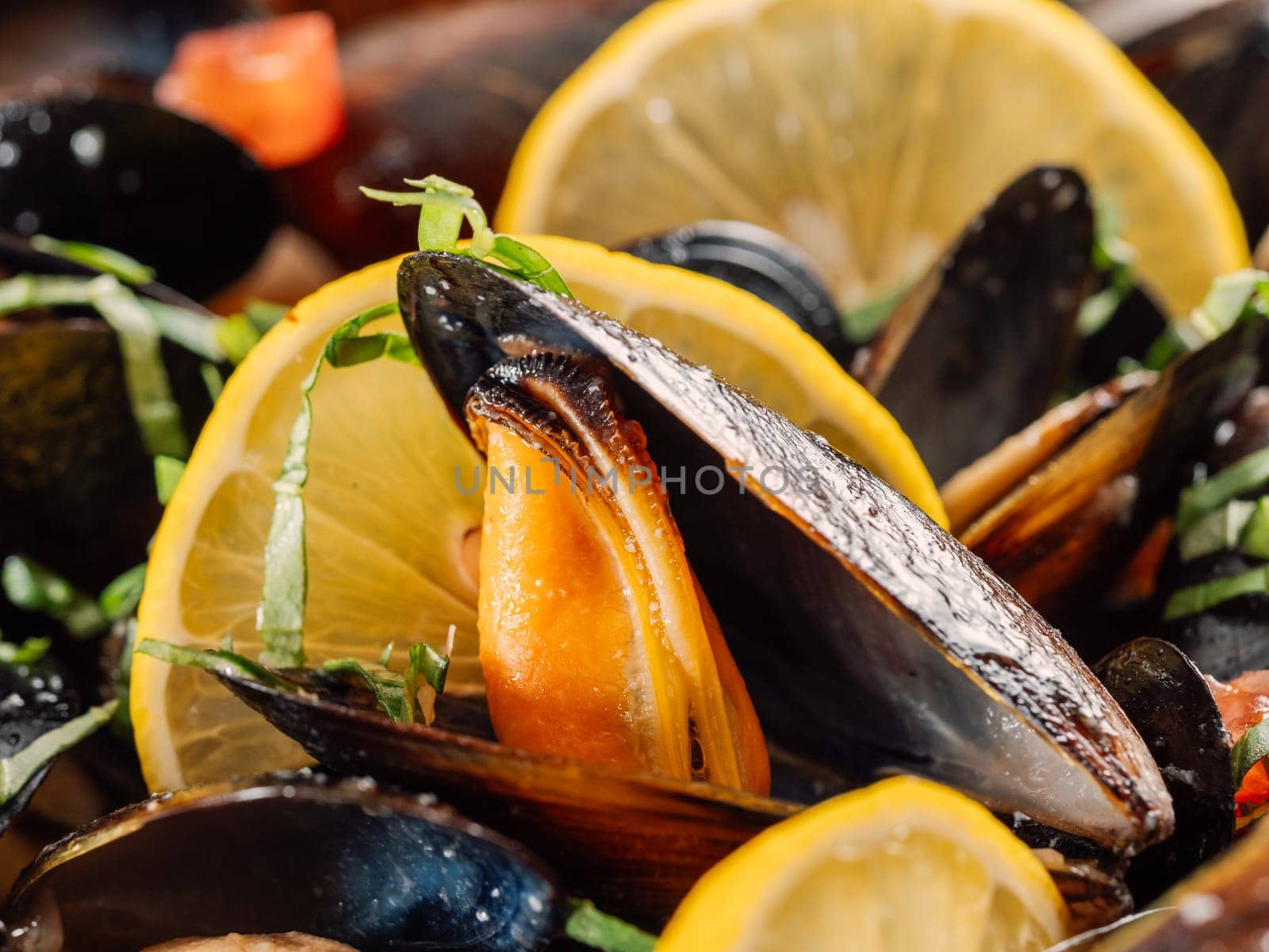 cooked mussels with lemon in white bowl by fascinadora