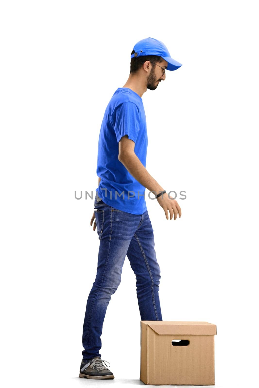 A male deliveryman, on a white background, full-length, with a box.