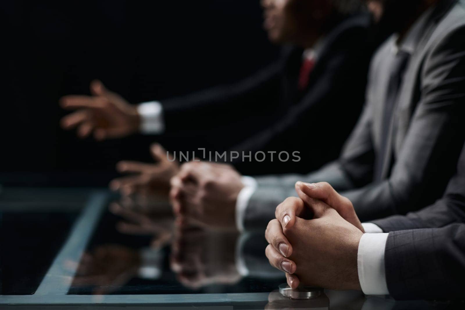Cropped shot of unrecognizable people, male hands of business people on the table close-up