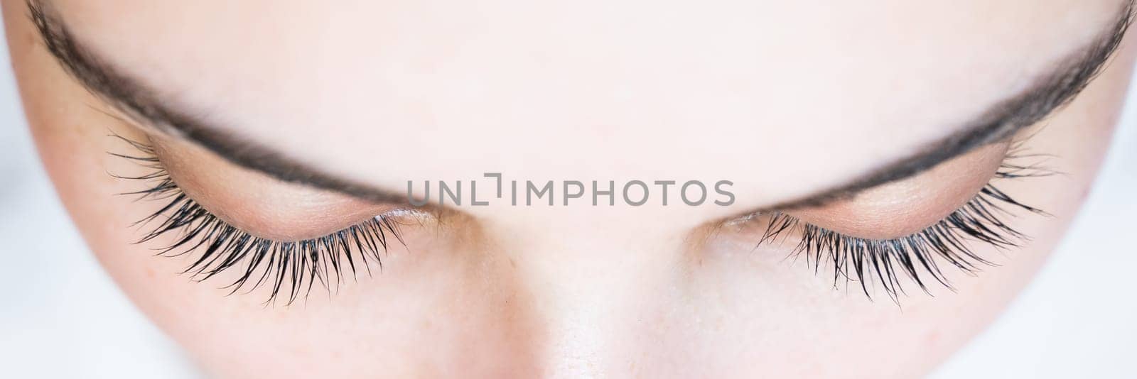 Close-up of a caucasian woman after eyelash lamination procedure. by mrwed54