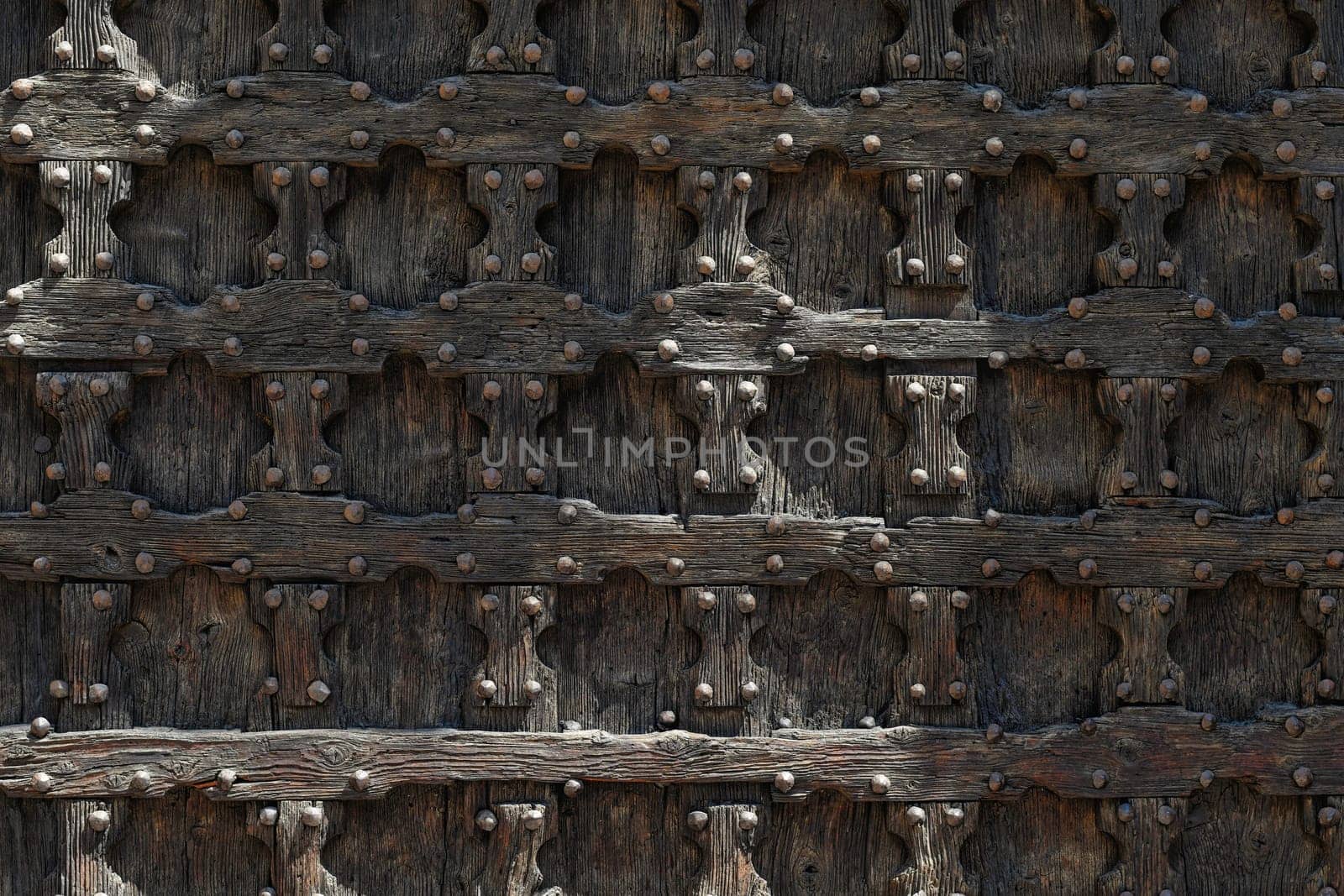 Wooden brown door with ancient square patten