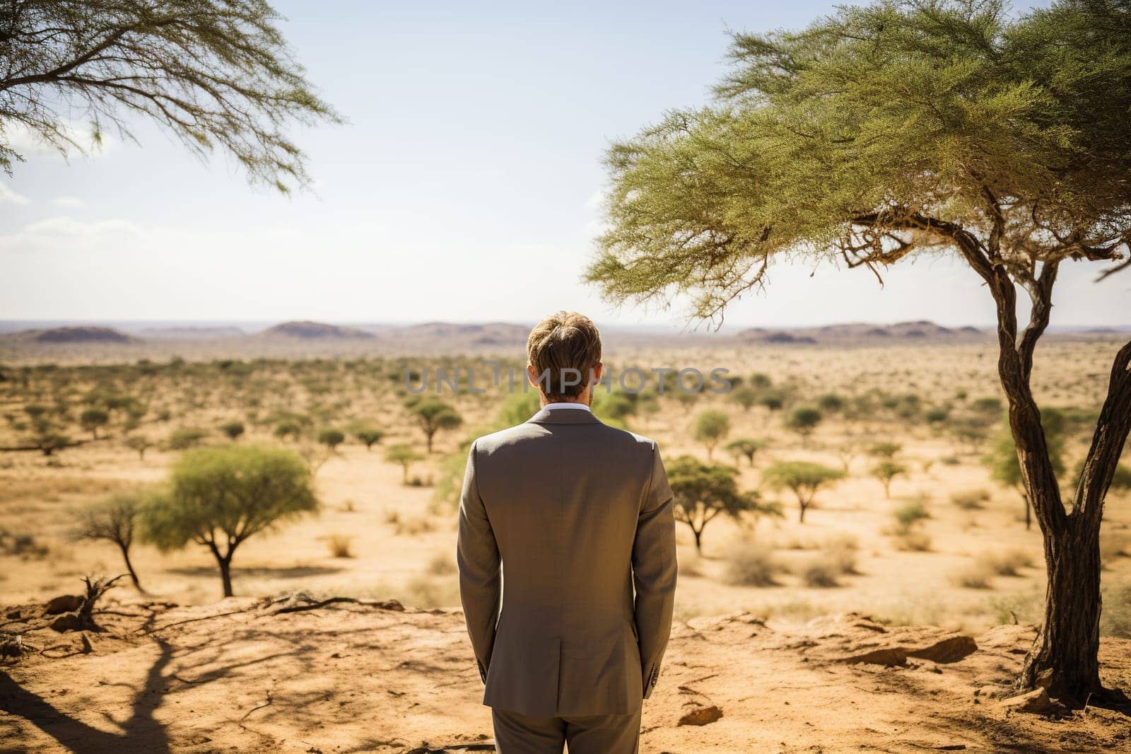 Rear view of a man in a business suit in the desert. Generated by artificial intelligence by Vovmar