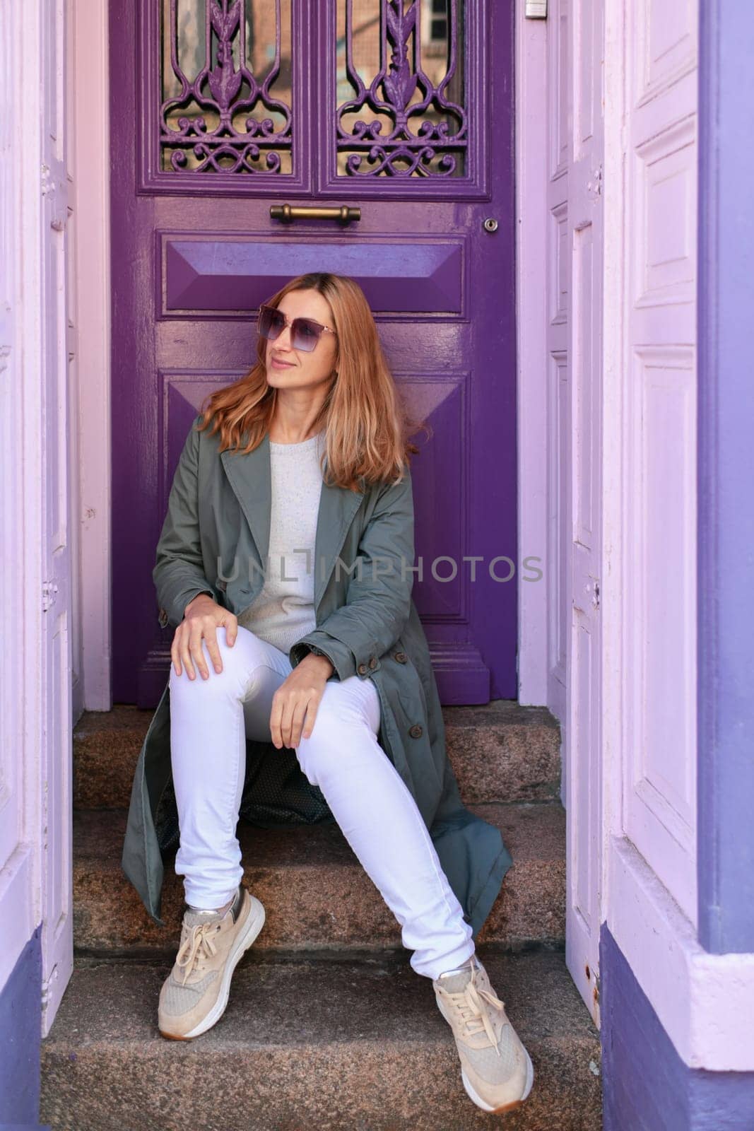 Young woman near purple door