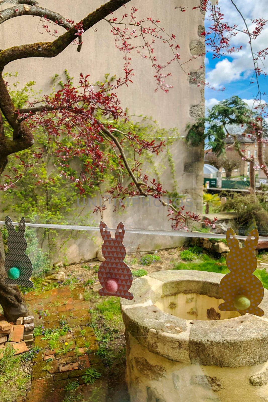 View of the garden through the window with Easter bunnies Decoration