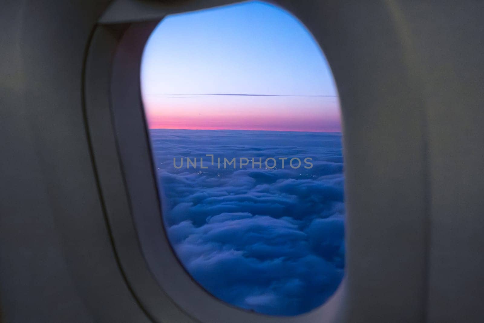 Amazing view of clouds and sunset in window on an airplane.
